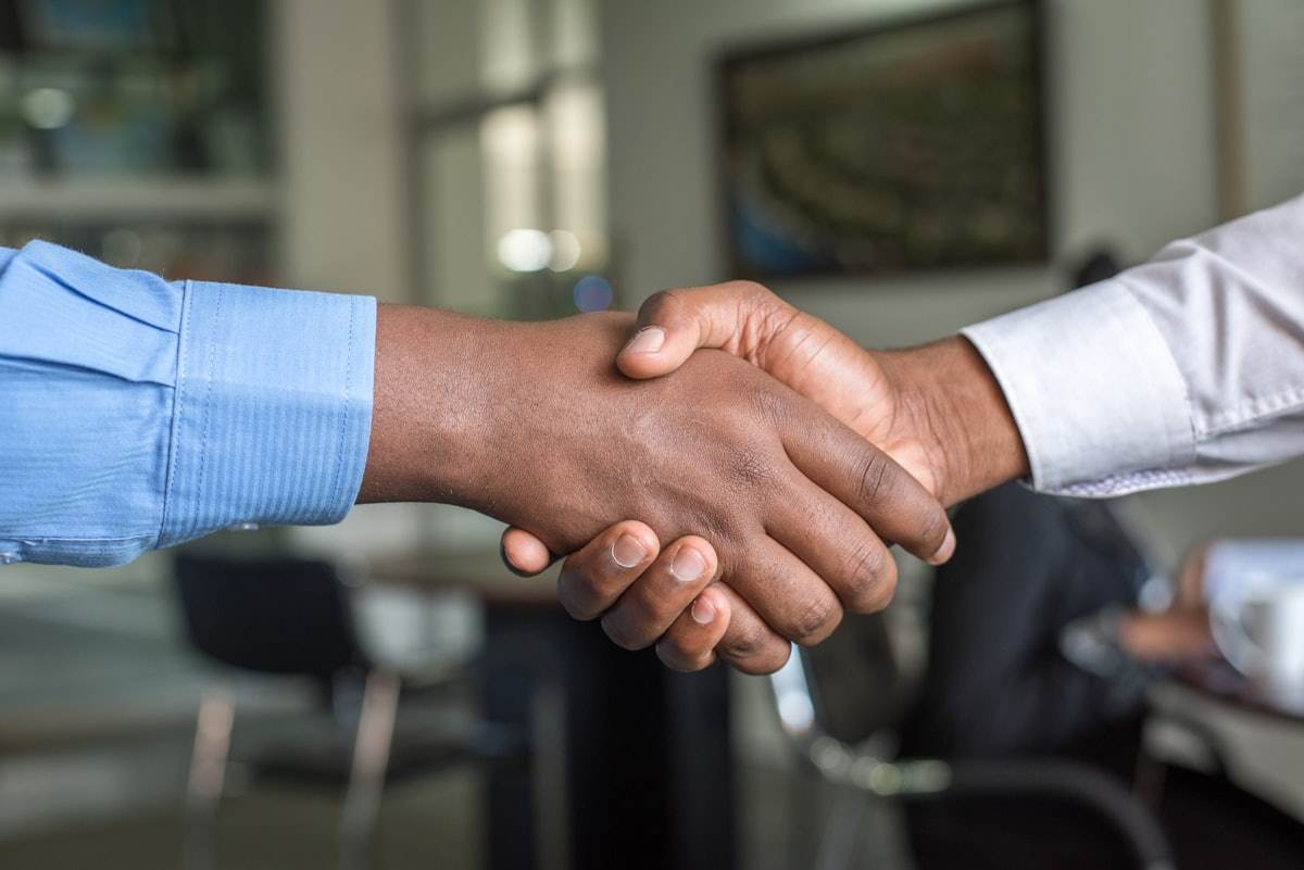 Two people shaking hands after a meeting